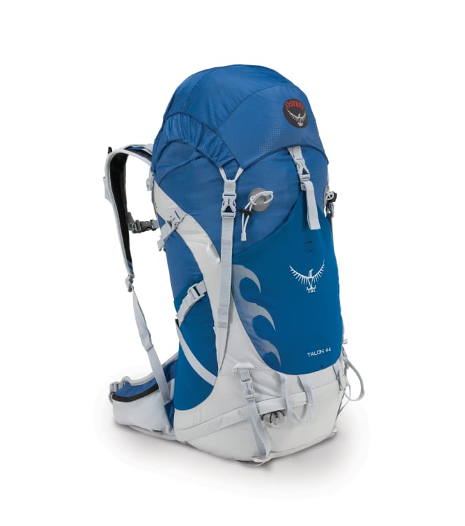 En koboltblå backpacker-ryggsekk med sølvhvite stropper og detaljer. «Talon 44» og Osprey-logoen i svart, rødt og hvitt er brodert på.