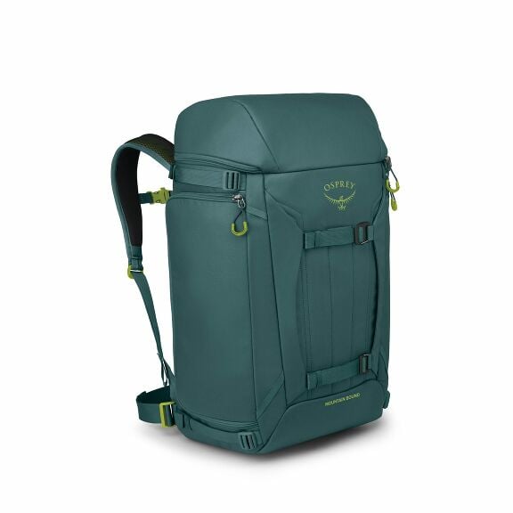 The image showcases a sturdy and functional Osprey backpack designed for outdoor use. It is primarily a teal color with some lime green accents, such as on the zippers and the logo. The backpack appears to have a rectangular shape, featuring multiple stra