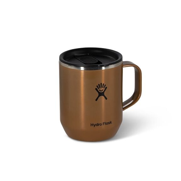 A copper-colored stainless steel mug with a black lid and handle. The Hydro Flask logo is centered on the front, conveying a sleek, modern design.