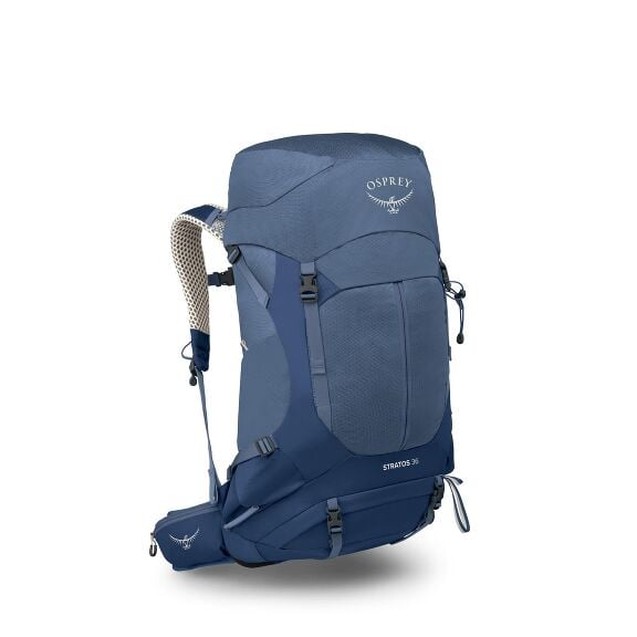 The image depicts a blue Osprey Stratos 36 backpack designed for hiking or outdoor use. The backpack features a sleek and structured design with various straps and buckles for secure closure and adjustment. It has a top lid and side pockets for additional