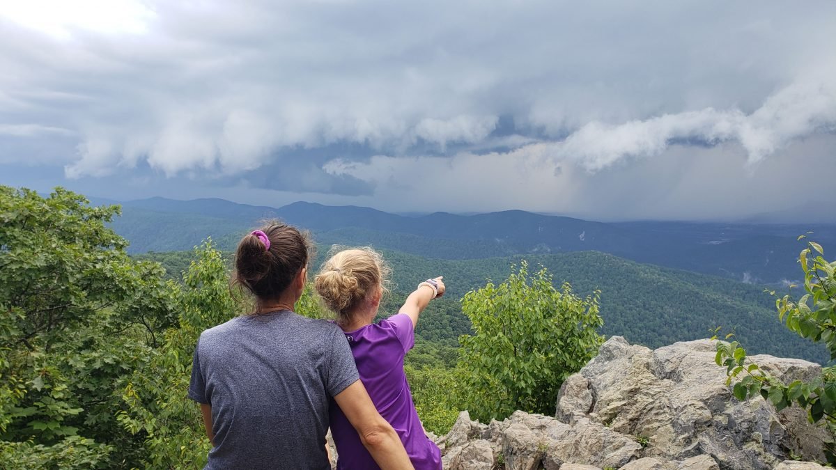 Jenna and Ayla Crawley at an overlook on the AT pointing in the distance