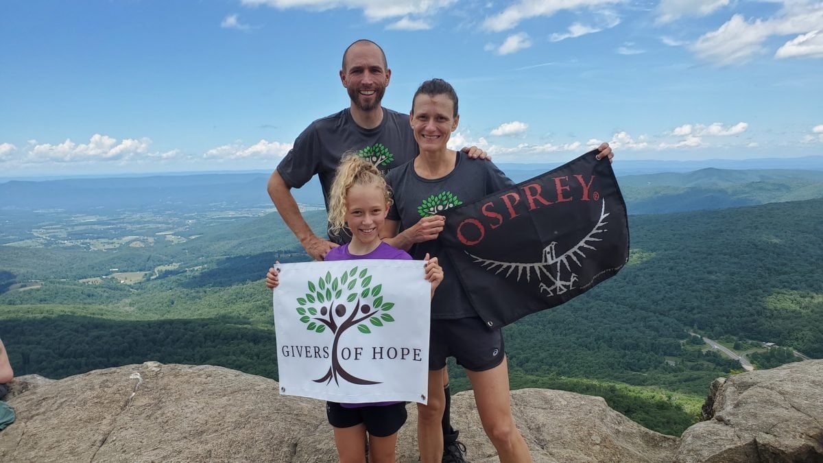 Crawley family sporting their Osprey and Givers of Hope flags at an overlook on the AT.