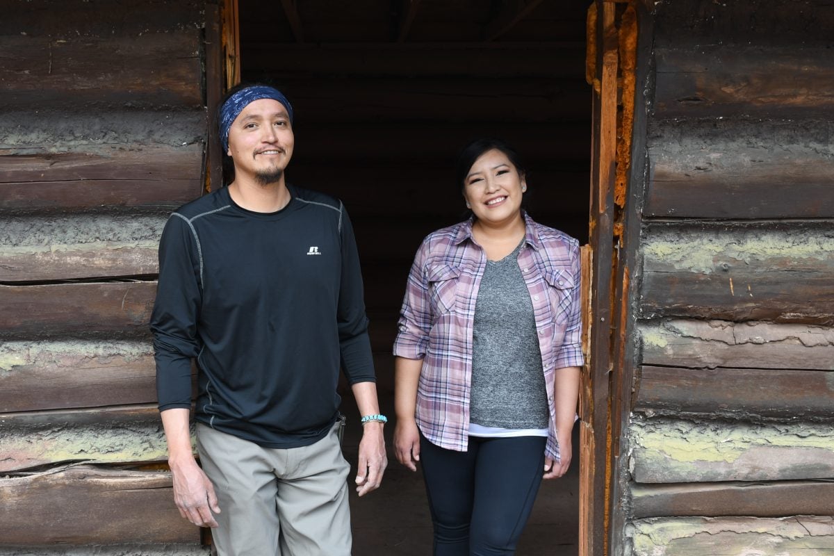 The people standing in a doorway, smiling
