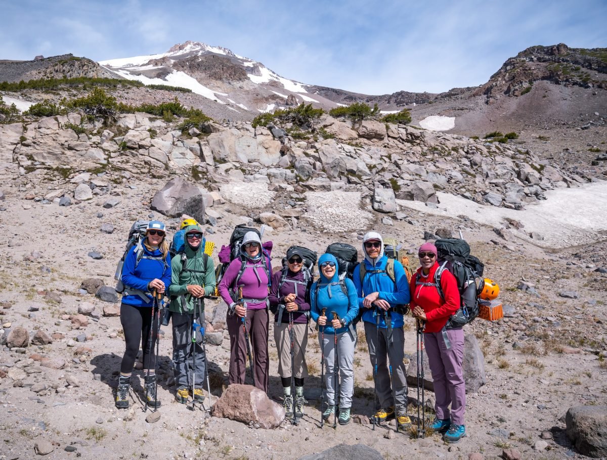 A group of climbers geared up and posing together