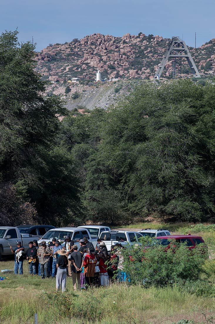 A group of people on native land, with a proposed mining site in the background
