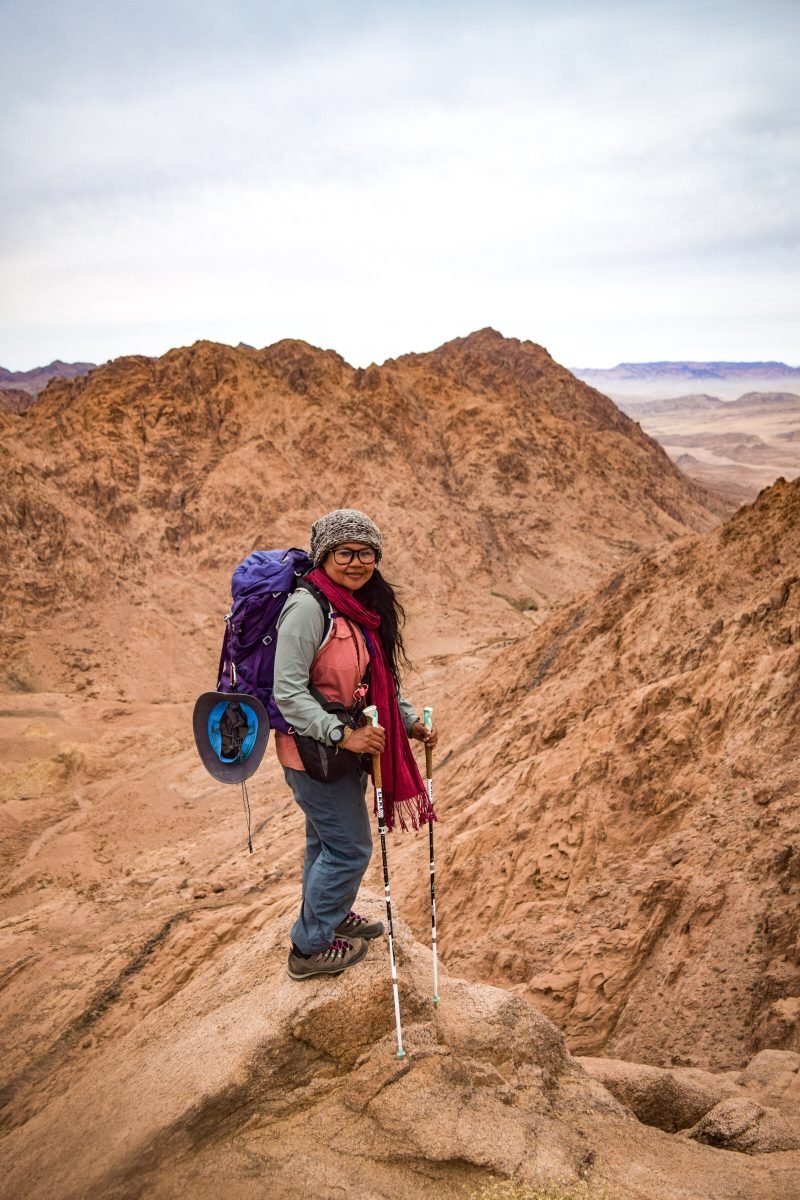 A woman trekking along the Sinai Trail in backpacking gear