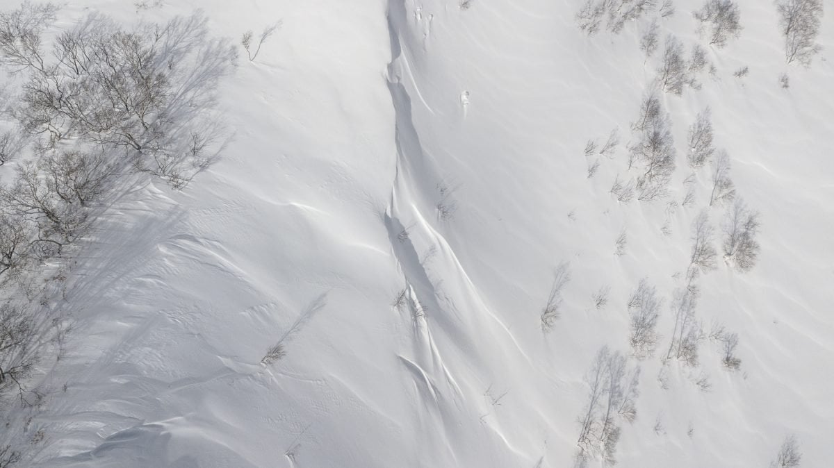 A bird's eye view of a freshly snowed over mountain