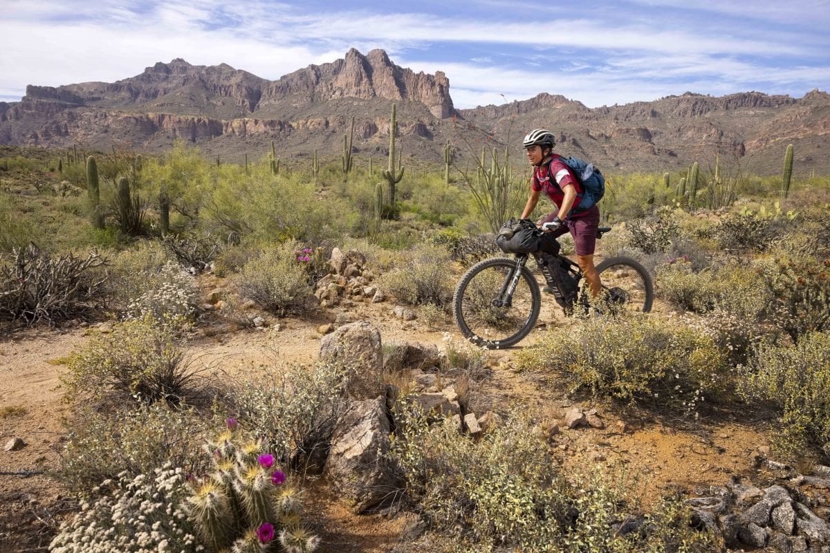 A person on a bike in a desert landscape