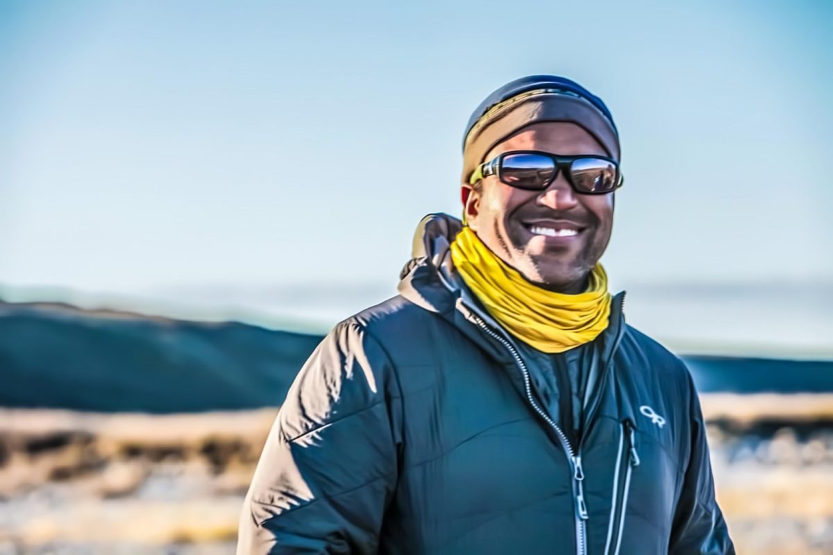 A man in hiking gear standing and posing 