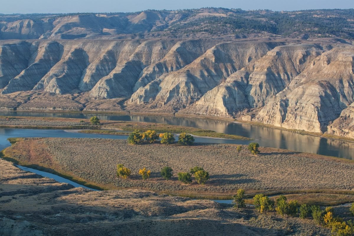 A landscape view of the Missouri River, with rolling hills in the background