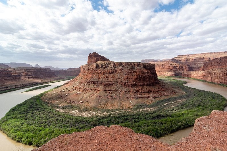 A landscape view of a rock formation and a river in Canyonlands