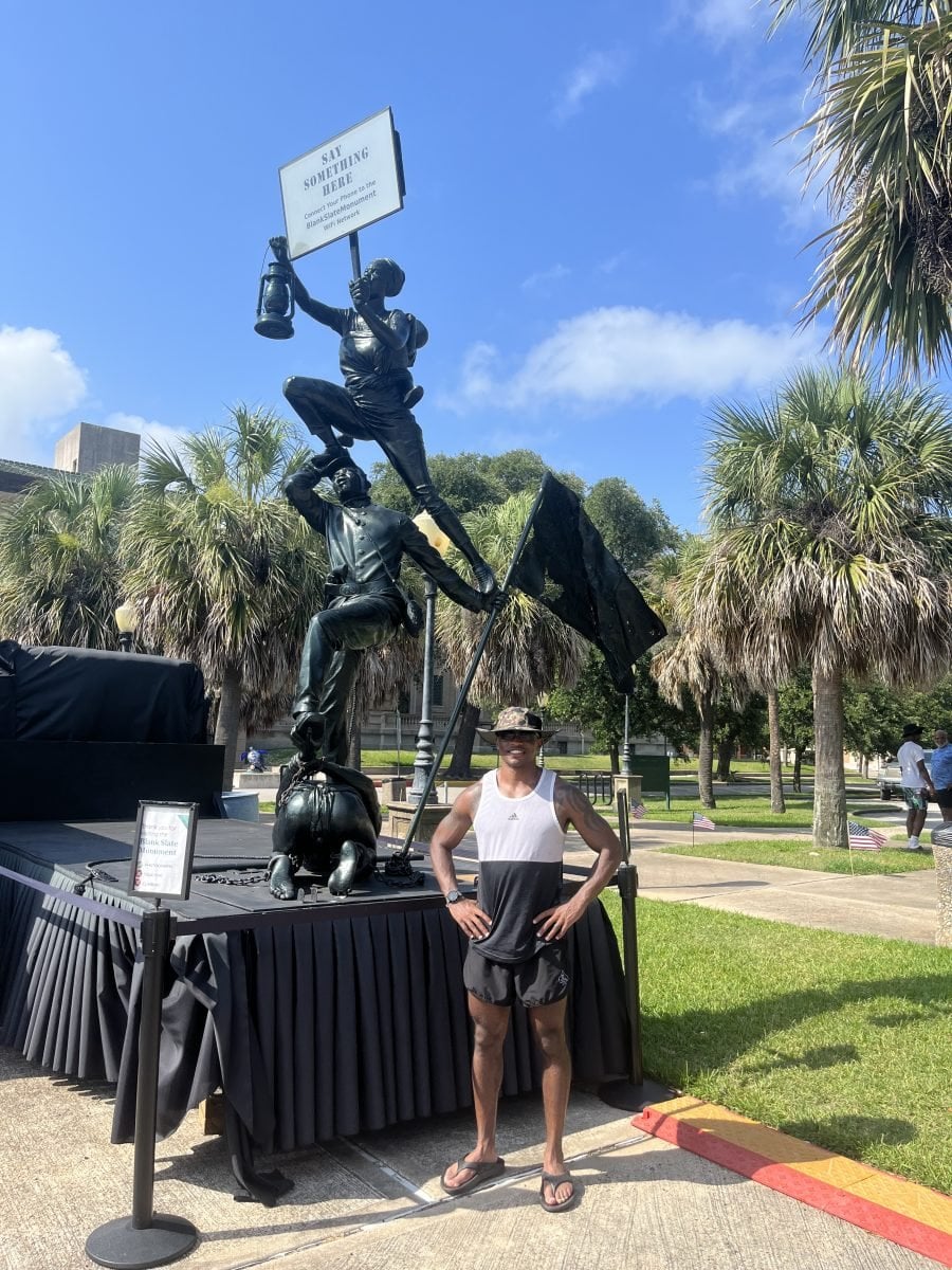 A man standing in front of a statue in Texas
