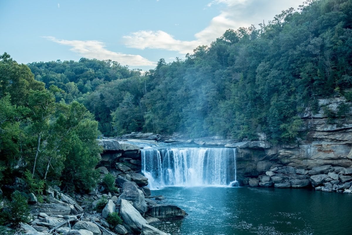 A waterfall surrounded by trees and rocky cliffs