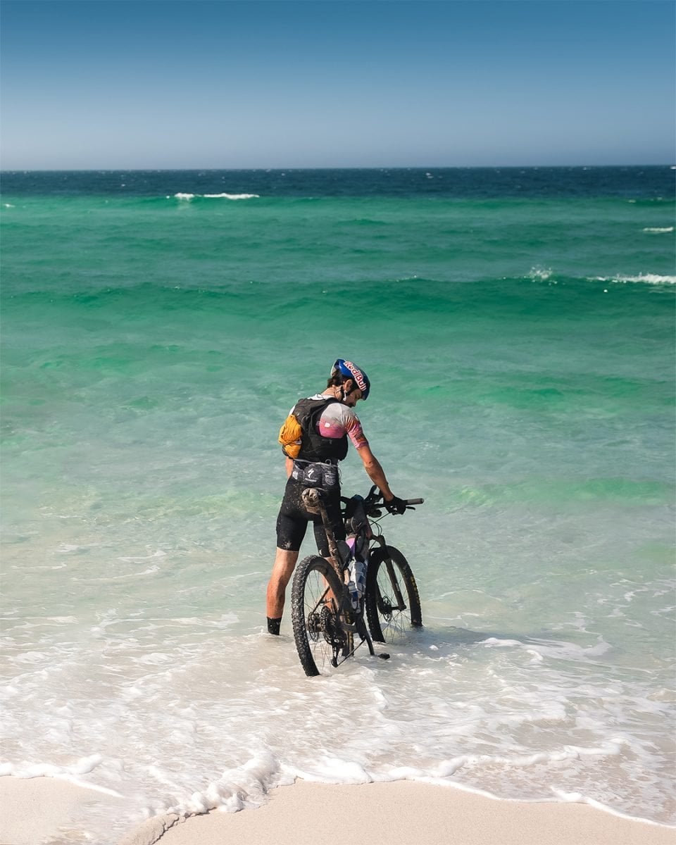 Osprey Athlete Payson McElveen at the shores of the Tasmanian coast