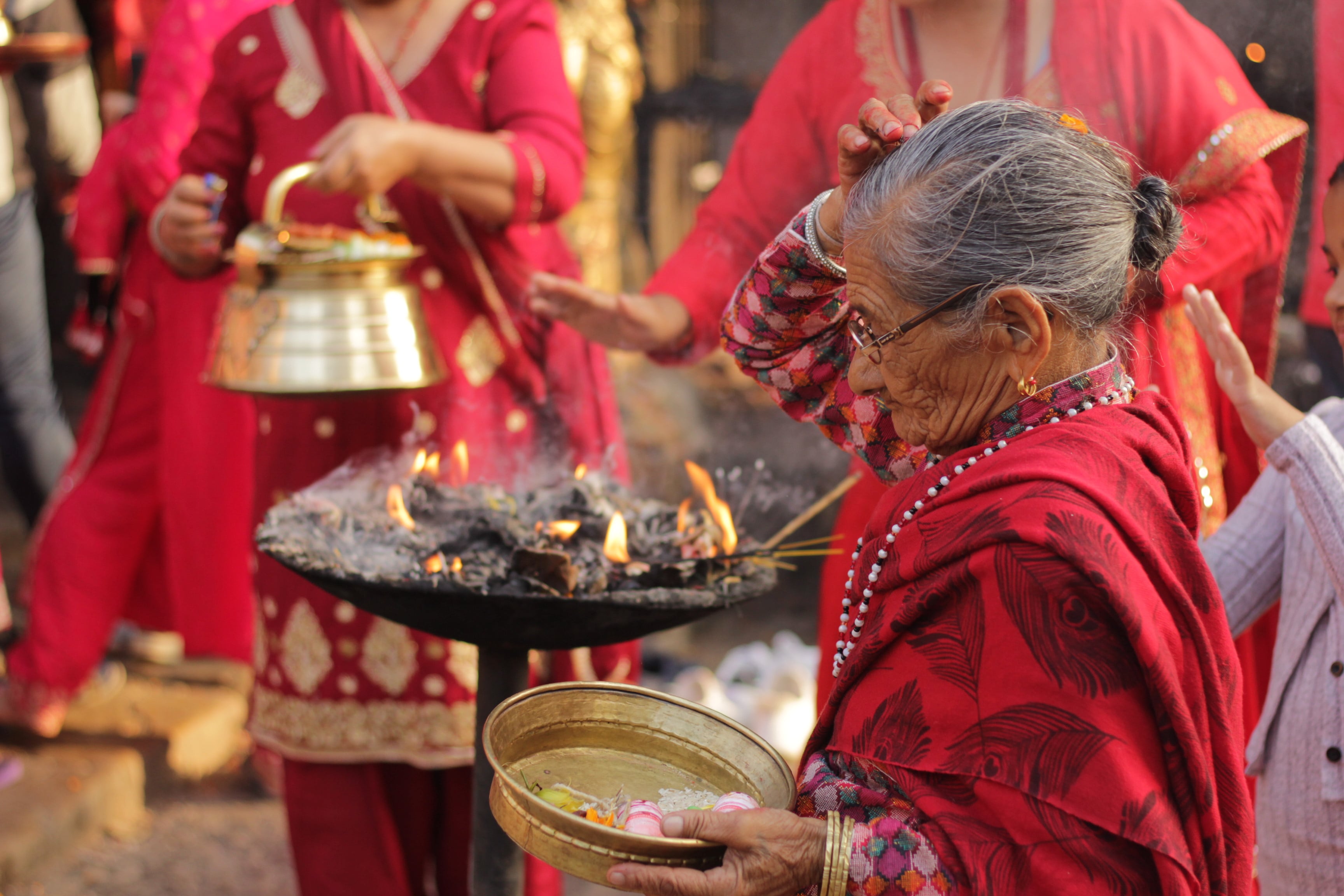 A local Nepalese woman dabs ash on her head at a temple. (Photo credit: Iona Brannon)