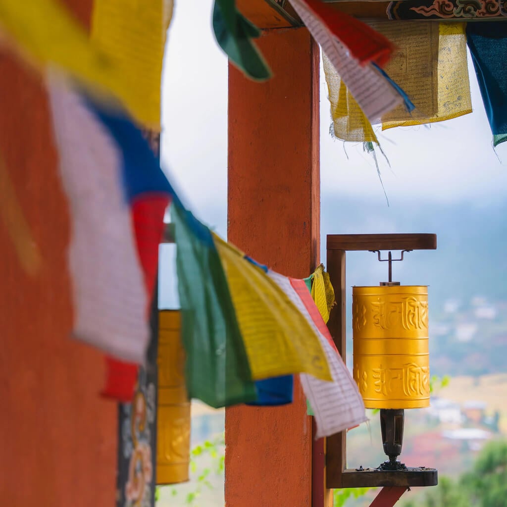 A prayer wheel surrounded by prayer flags.