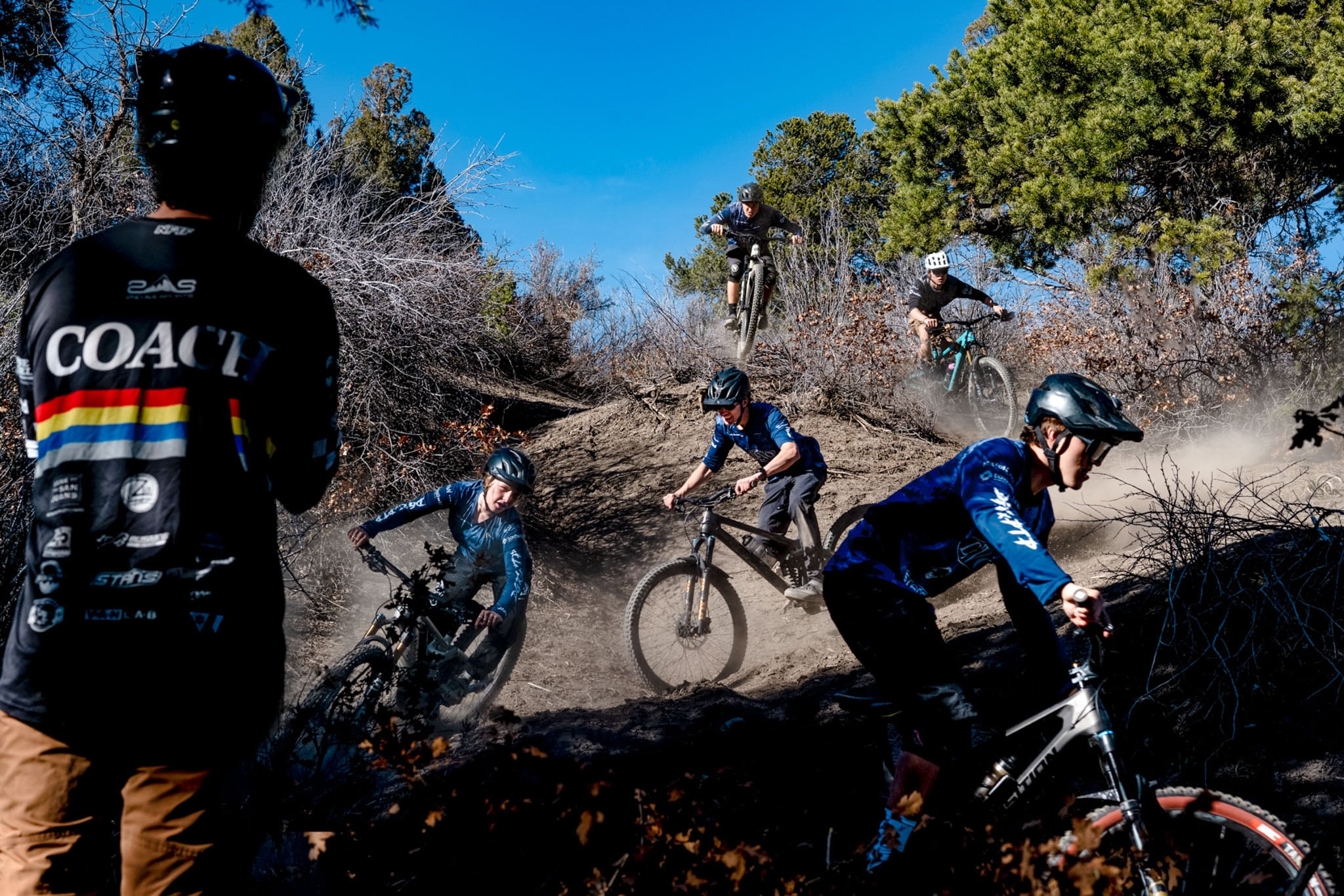 A group of cyclists coming down switchbacks.