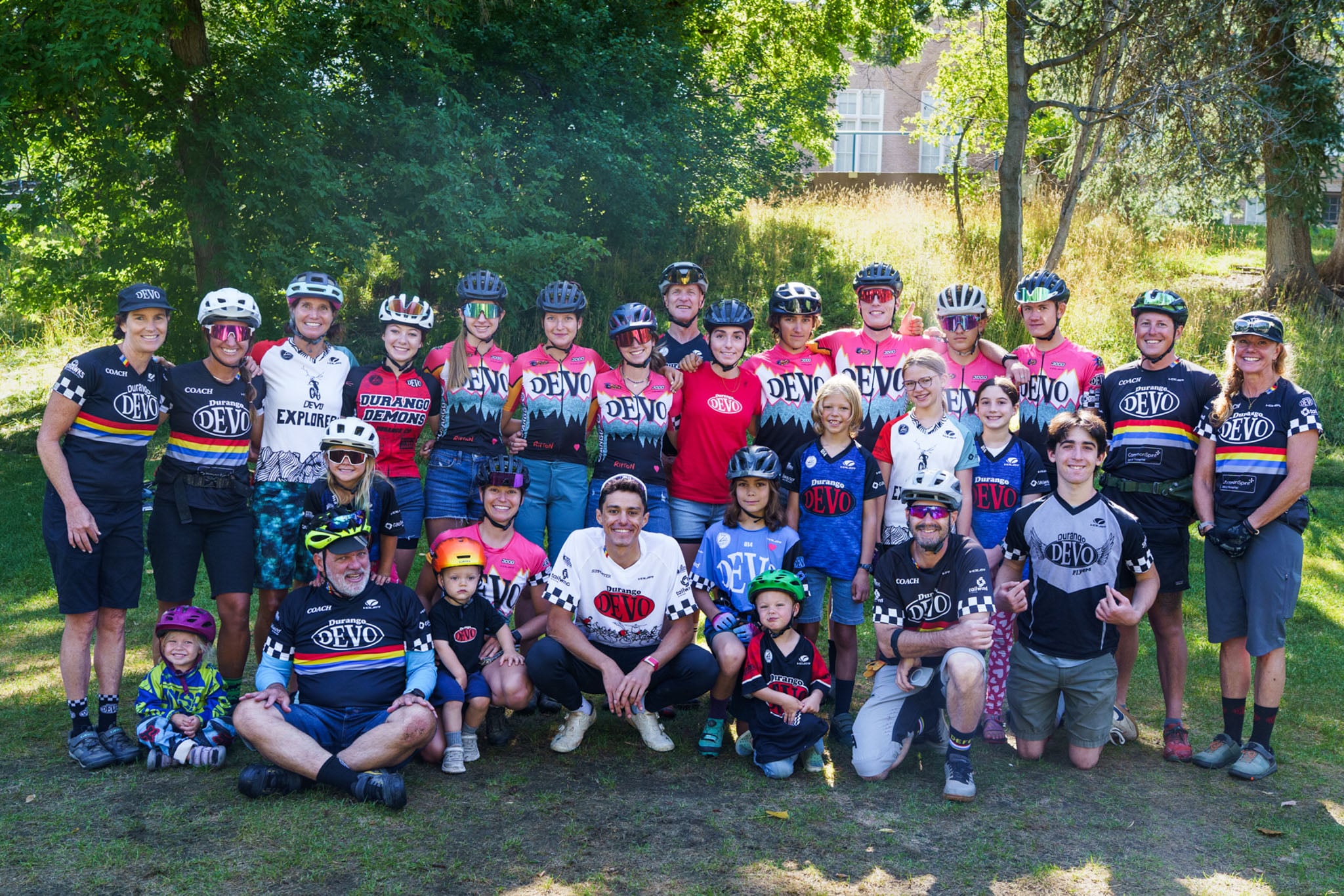 A group photo of people in bike helmets wearing Durango Devo uniforms.