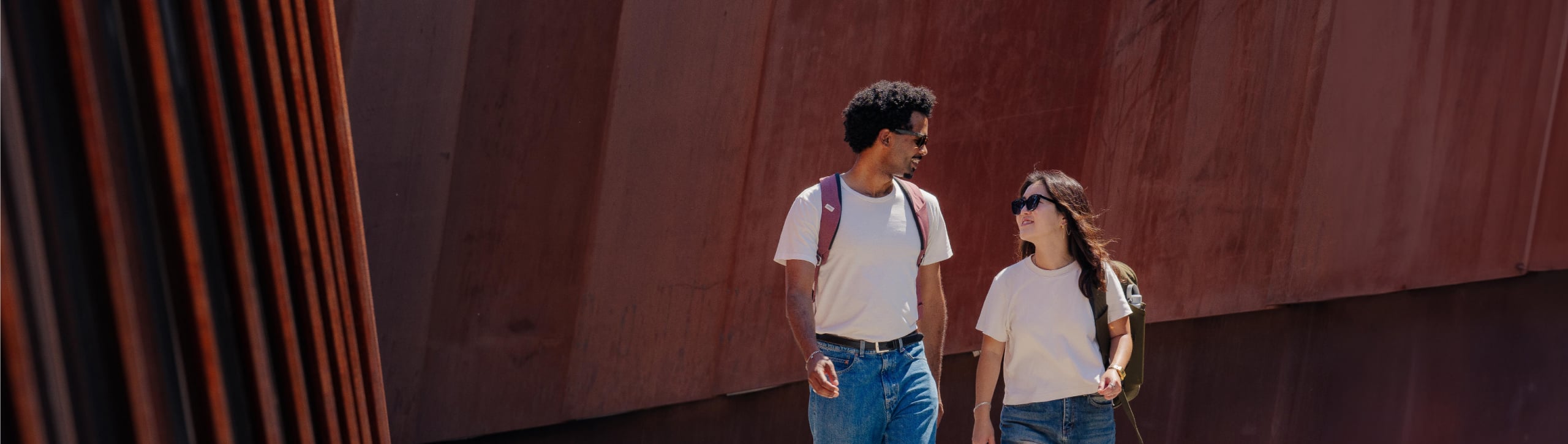 Two people wearing osprey backpacks