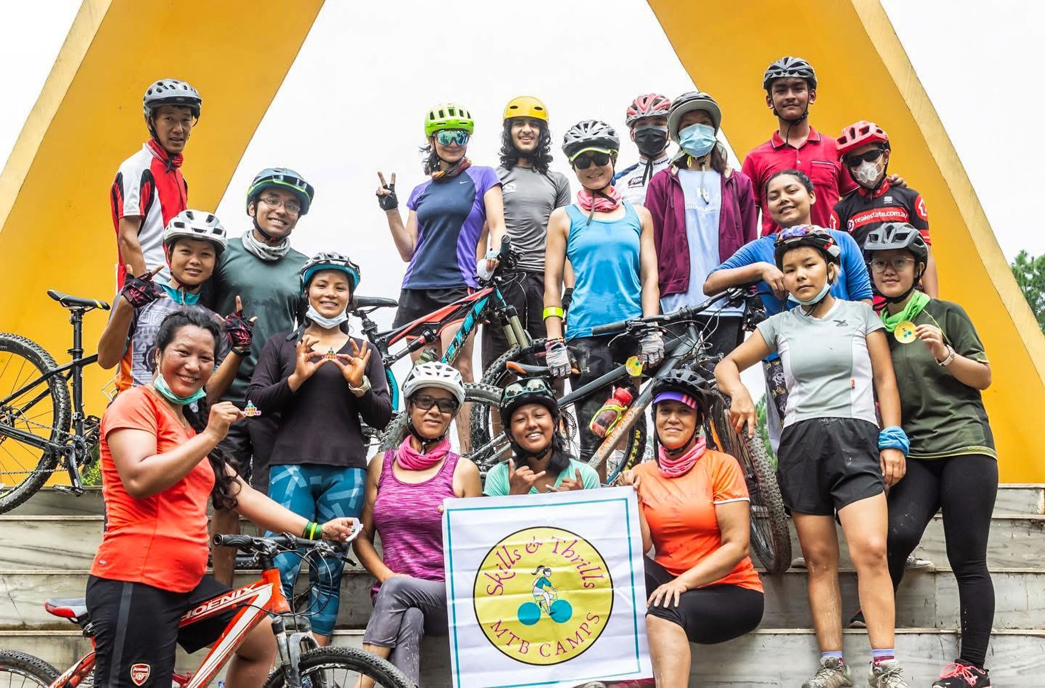 A group of people pose with a Skills & Thrills banner.