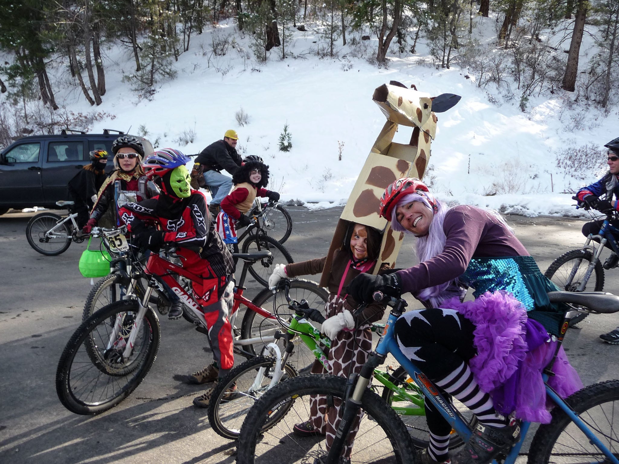 A group of cyclists in Halloween costumes.
