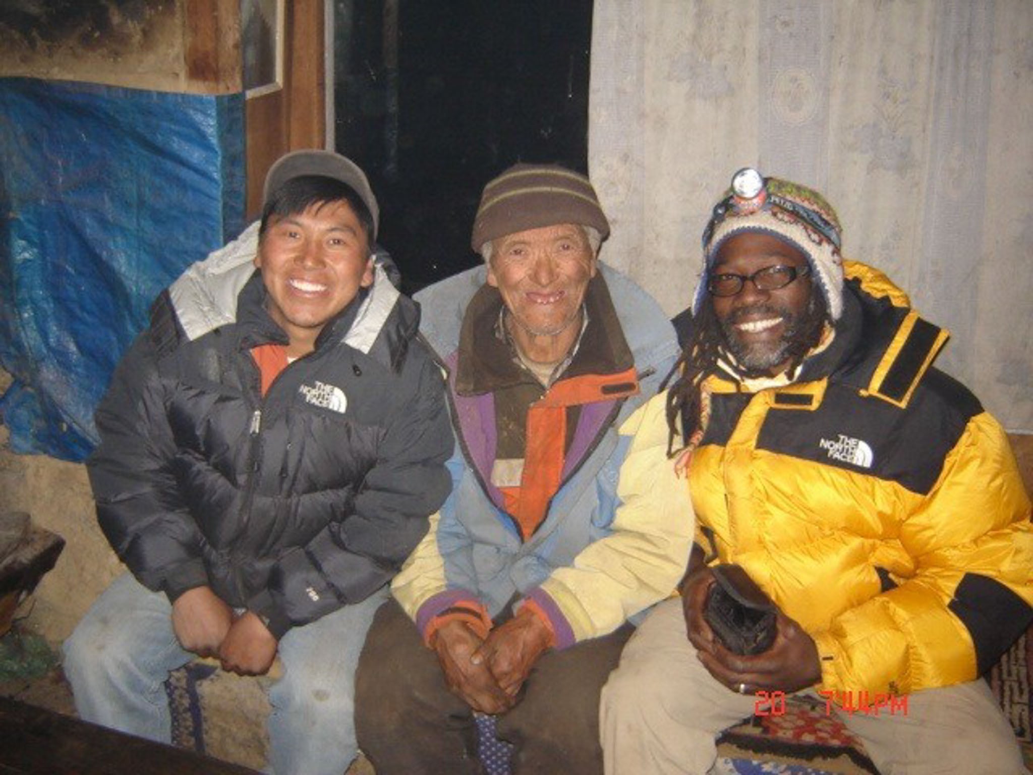 Three men posing in winter coats.